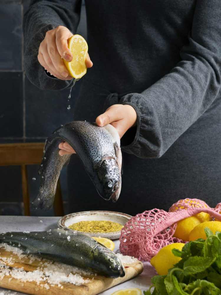 side-view-cook-preparing-raw-trout